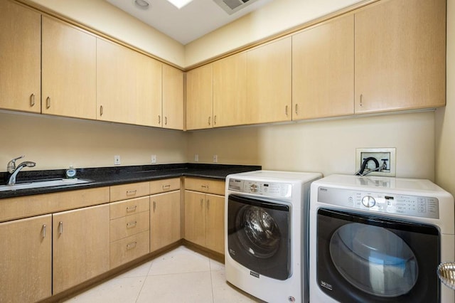 washroom with independent washer and dryer, cabinets, light tile patterned floors, and sink