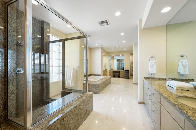 bathroom with tile patterned floors, vanity, and separate shower and tub