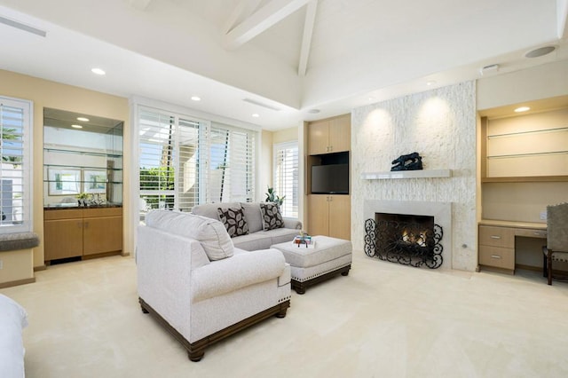 carpeted living room with a fireplace and lofted ceiling with beams