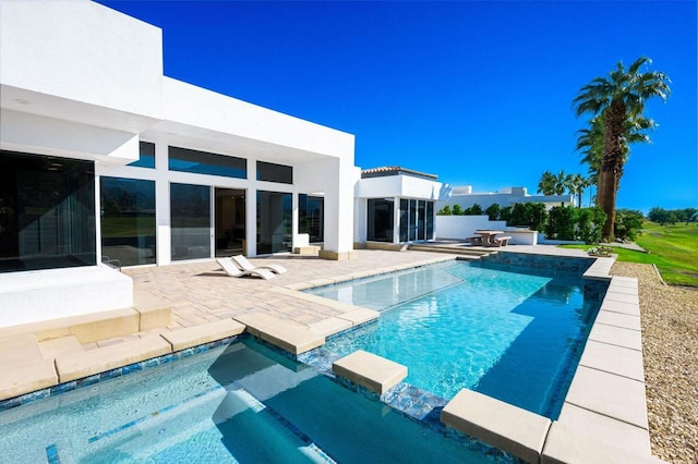 view of swimming pool with a patio area and an in ground hot tub