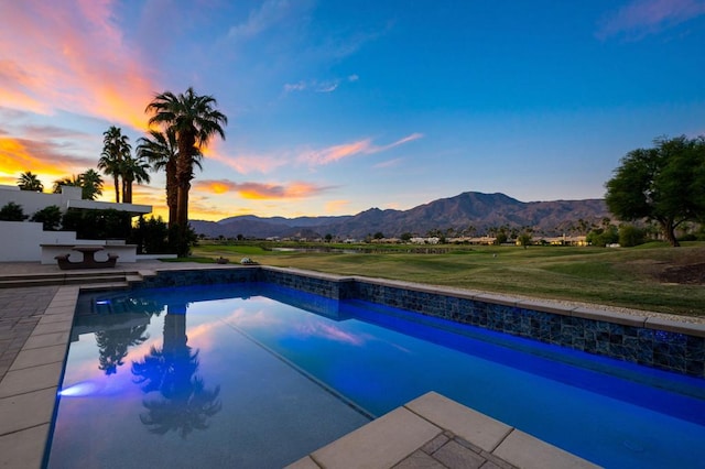 pool at dusk with a mountain view