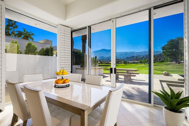 sunroom / solarium featuring a mountain view and a healthy amount of sunlight