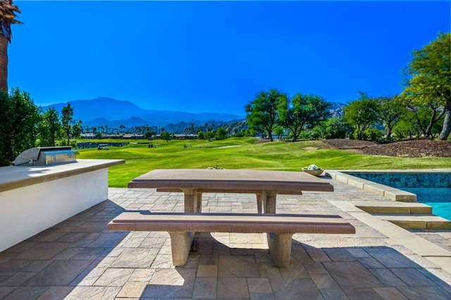 view of patio / terrace featuring a mountain view and an outdoor kitchen