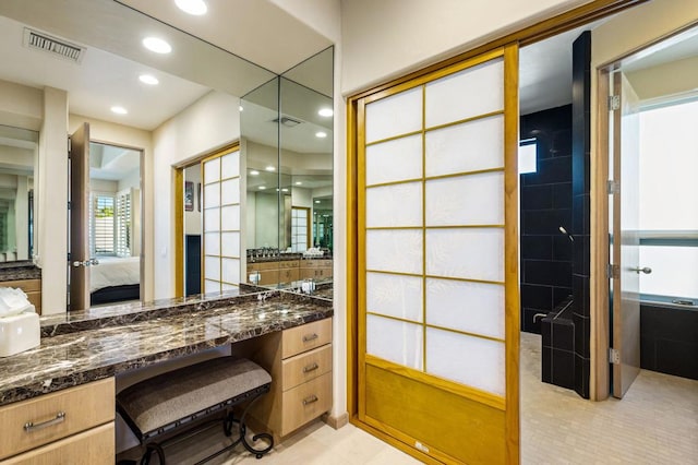 bathroom with tile patterned floors and vanity