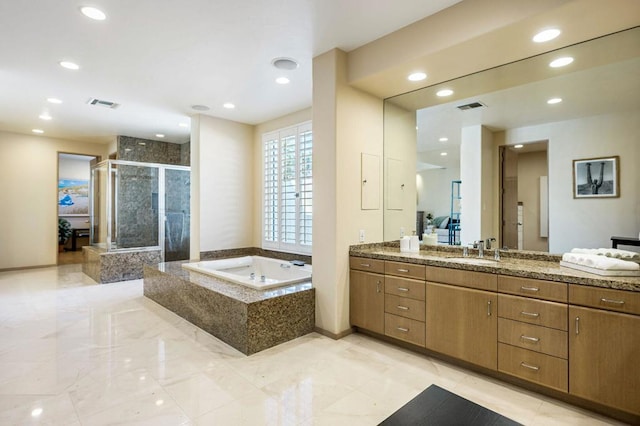 bathroom with separate shower and tub and vanity