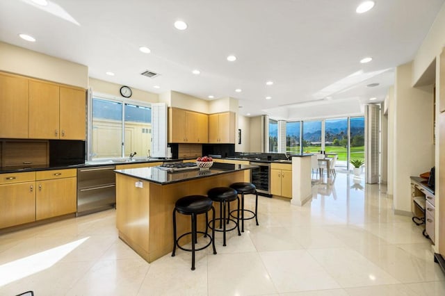 kitchen featuring a center island, wine cooler, and a healthy amount of sunlight