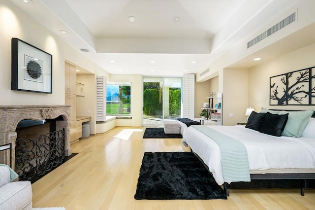 bedroom featuring access to exterior and light hardwood / wood-style flooring