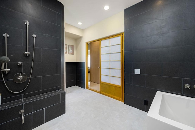 bathroom featuring separate shower and tub and tile walls