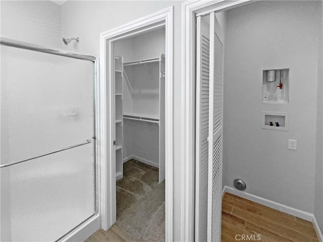 bathroom featuring wood-type flooring and a shower with door