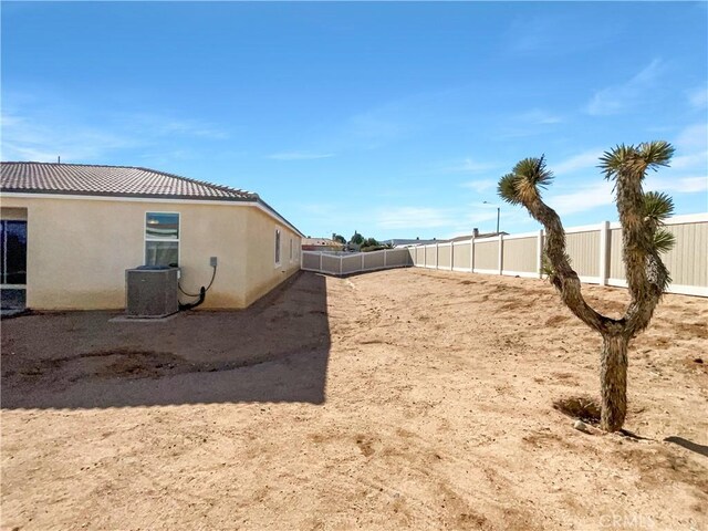 view of yard with central air condition unit