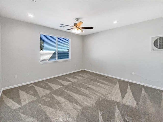 spare room with ceiling fan and carpet