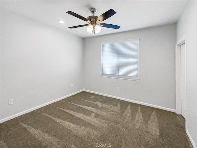 carpeted spare room with ceiling fan