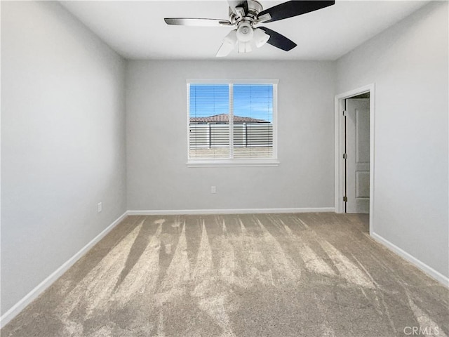 unfurnished room with ceiling fan and carpet