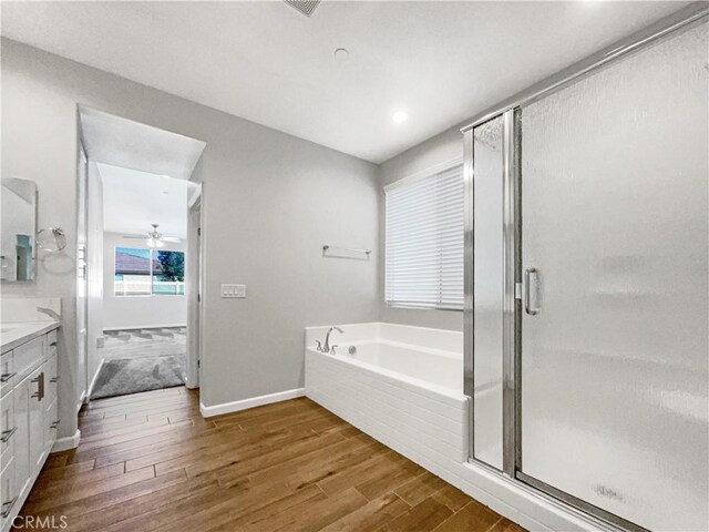 bathroom with ceiling fan, vanity, shower with separate bathtub, and hardwood / wood-style floors