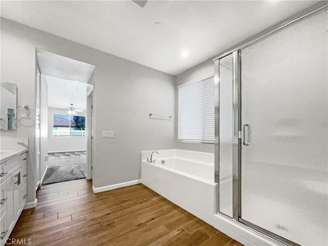 bathroom featuring vanity, ceiling fan, hardwood / wood-style flooring, and separate shower and tub