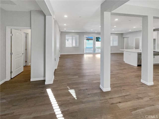 unfurnished living room with dark wood-type flooring