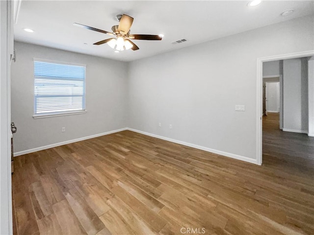 spare room with hardwood / wood-style floors and ceiling fan