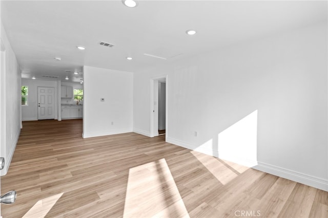 unfurnished living room with light hardwood / wood-style flooring