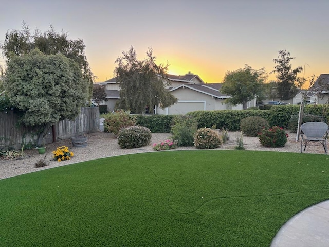 view of yard at dusk