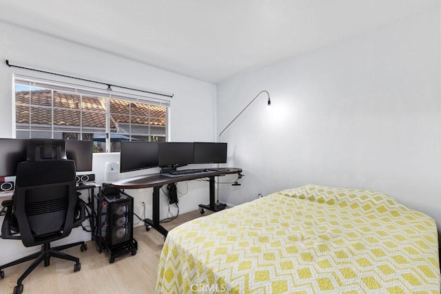 bedroom featuring light hardwood / wood-style floors and multiple windows