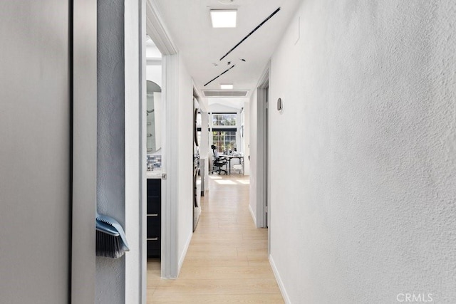 corridor with light hardwood / wood-style flooring