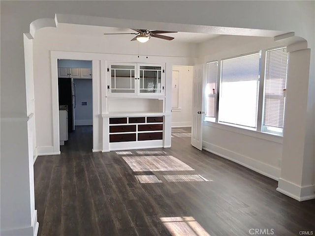 empty room featuring ceiling fan and dark hardwood / wood-style flooring