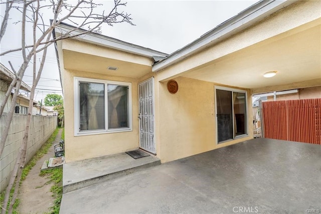 property entrance featuring a patio area