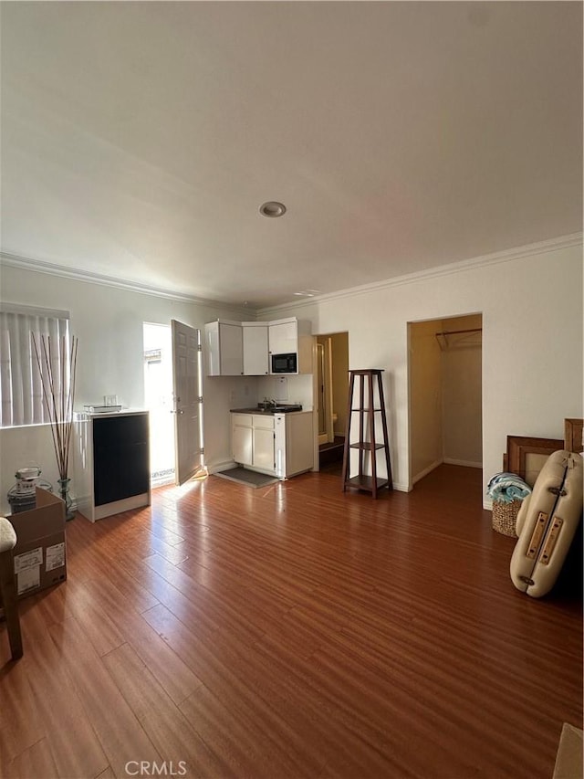 living room with dark hardwood / wood-style flooring and crown molding