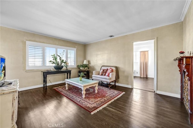 sitting room with dark hardwood / wood-style floors and crown molding