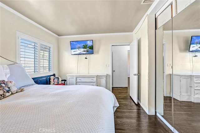 bedroom featuring dark hardwood / wood-style floors and crown molding