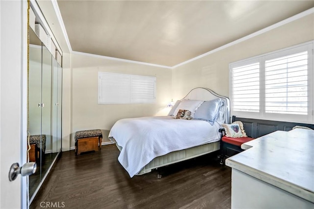 bedroom with dark hardwood / wood-style floors and crown molding