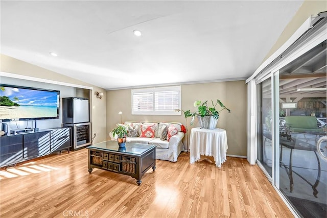 living room featuring light hardwood / wood-style floors and vaulted ceiling