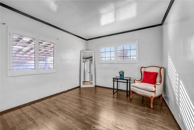 living area with dark hardwood / wood-style floors and ornamental molding