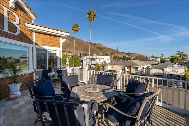 wooden deck with a patio area and a mountain view