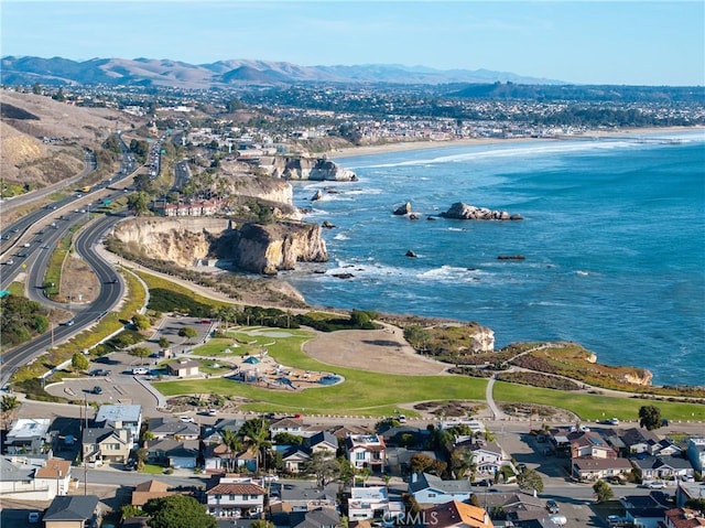 birds eye view of property with a water and mountain view