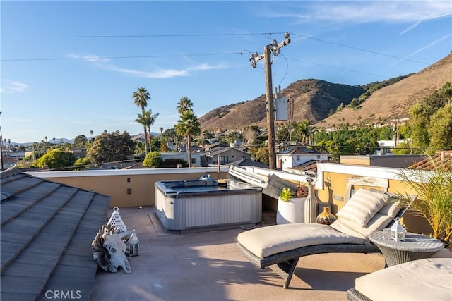 view of patio / terrace with a mountain view and a jacuzzi