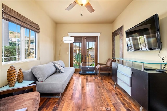 living room with ceiling fan and dark hardwood / wood-style flooring