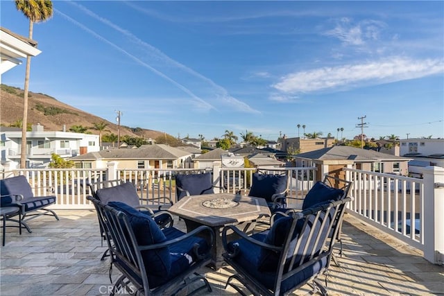 deck with a patio area and a mountain view