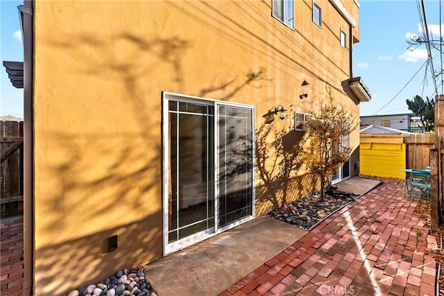 view of side of property featuring a patio