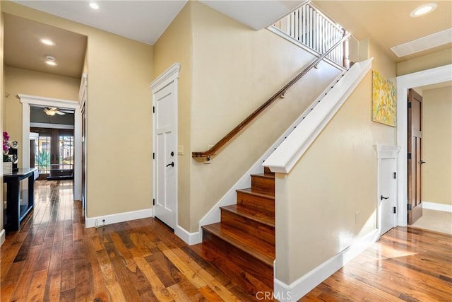 stairs featuring french doors and hardwood / wood-style floors