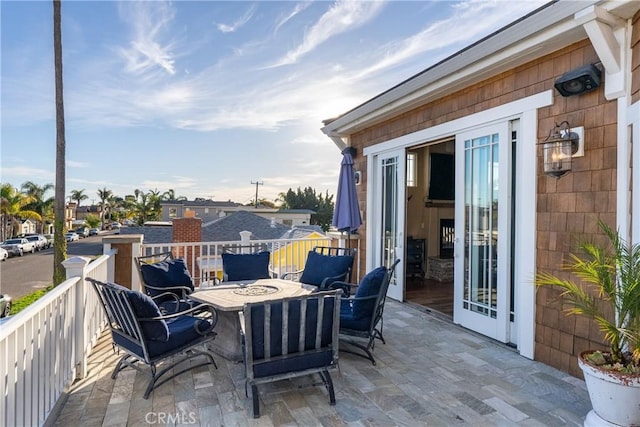 view of patio / terrace with french doors and a fire pit