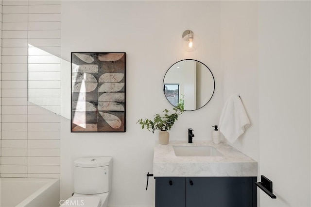 bathroom featuring vanity and toilet