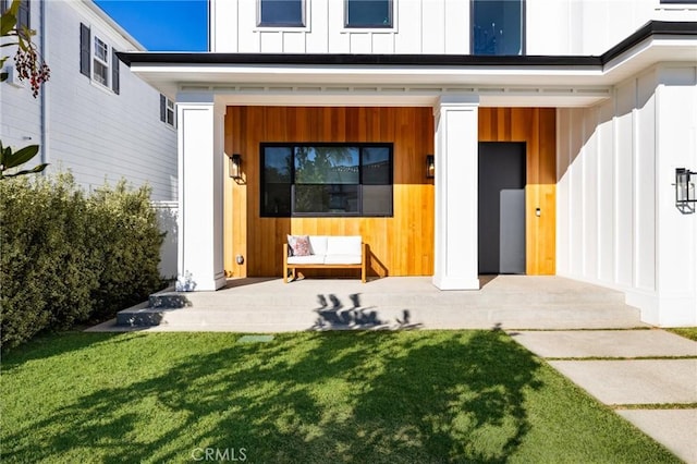 doorway to property featuring a lawn