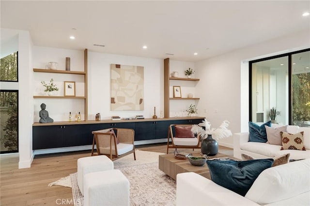 living room featuring plenty of natural light and light wood-type flooring