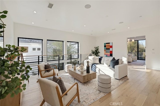 living room with a chandelier and light wood-type flooring