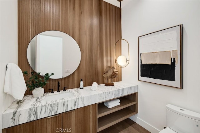 bathroom with hardwood / wood-style floors, vanity, and toilet