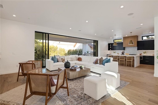 living room featuring light hardwood / wood-style floors and sink