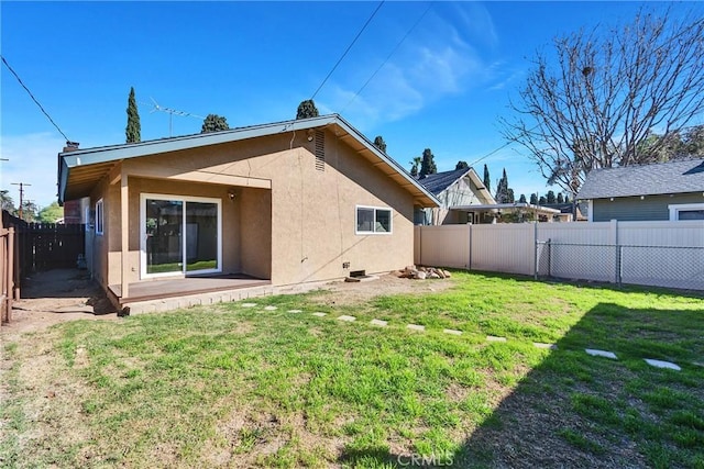 back of property featuring a lawn