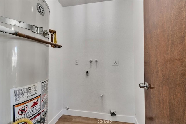 laundry room featuring washer hookup, water heater, electric dryer hookup, and wood-type flooring