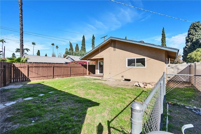 rear view of house with a yard